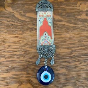 Evil eye with brass and tapestry